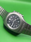 Titanium watch with a silver band on a green background